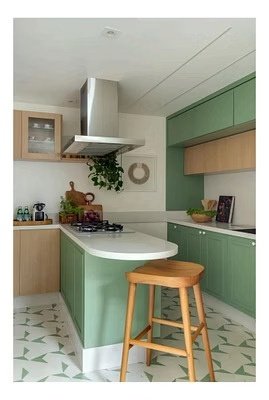 Custom sage green kitchen cabinetry with curved island