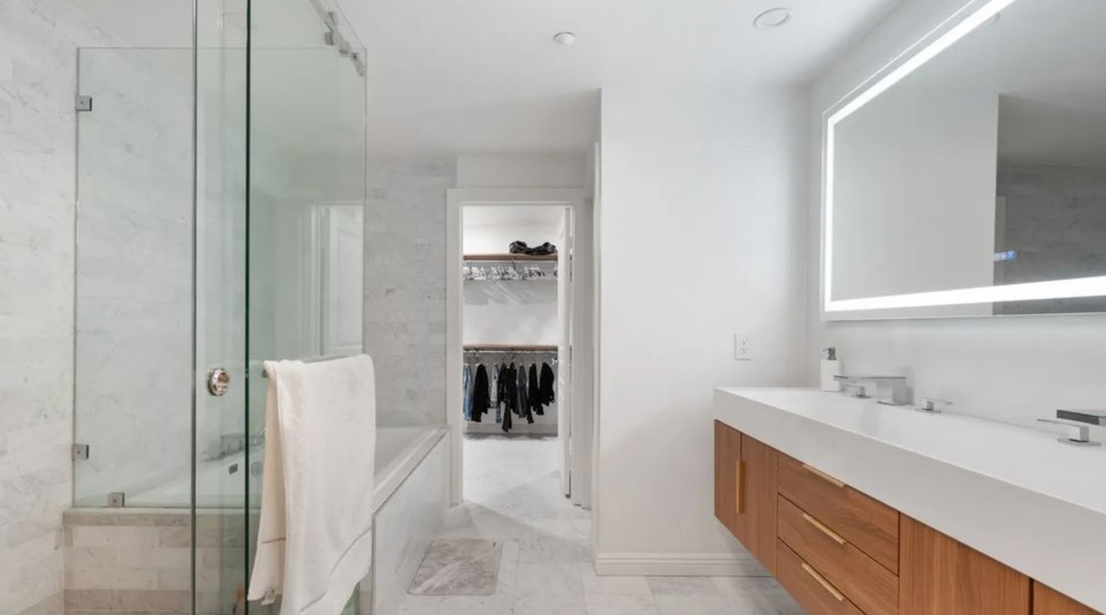 Custom floating wood vanity designed and installed by M11 Design Group in a South Florida home