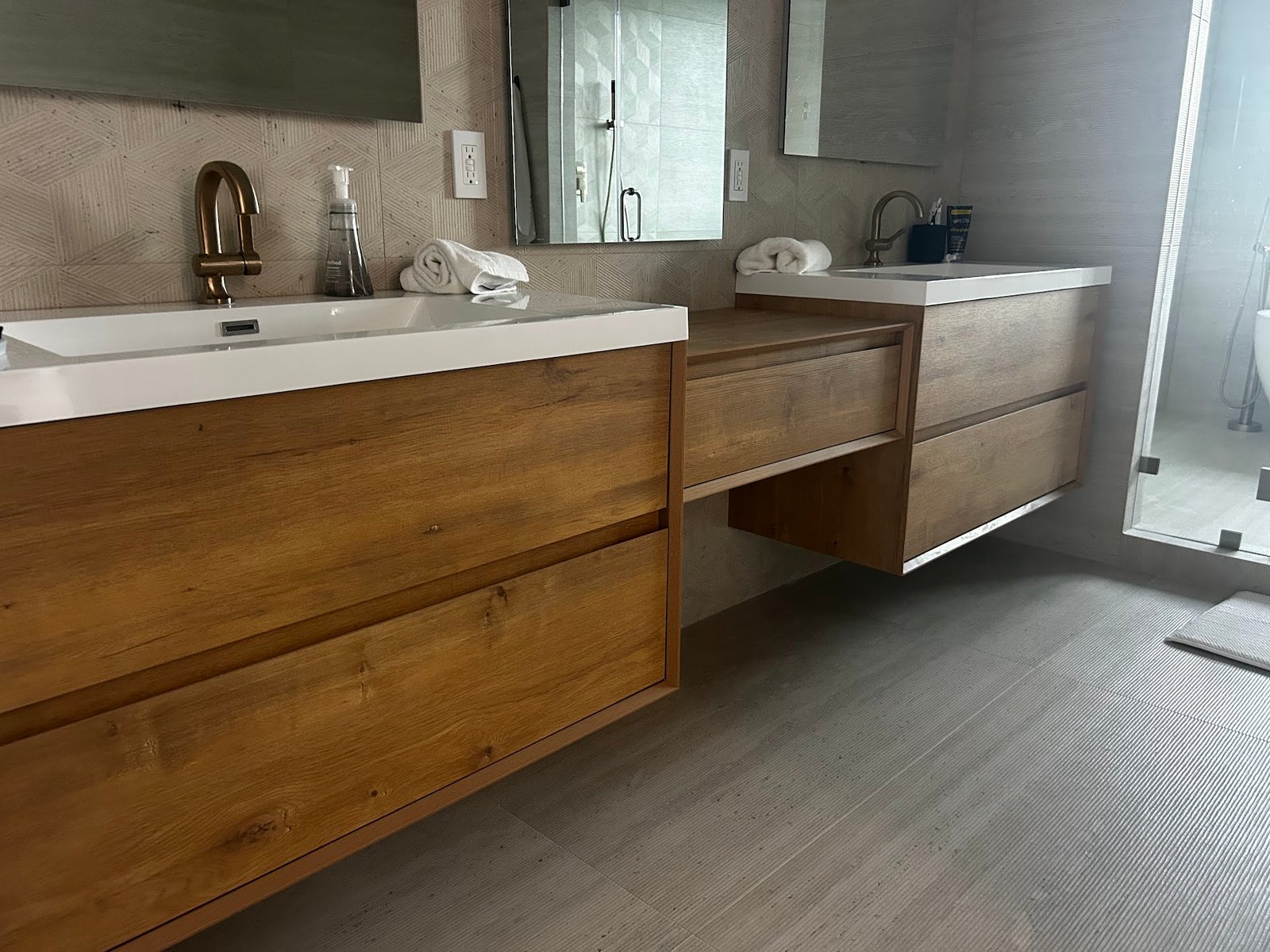 Double floating oak vanity built by M11 Design Group for a Coral Gables bathroom