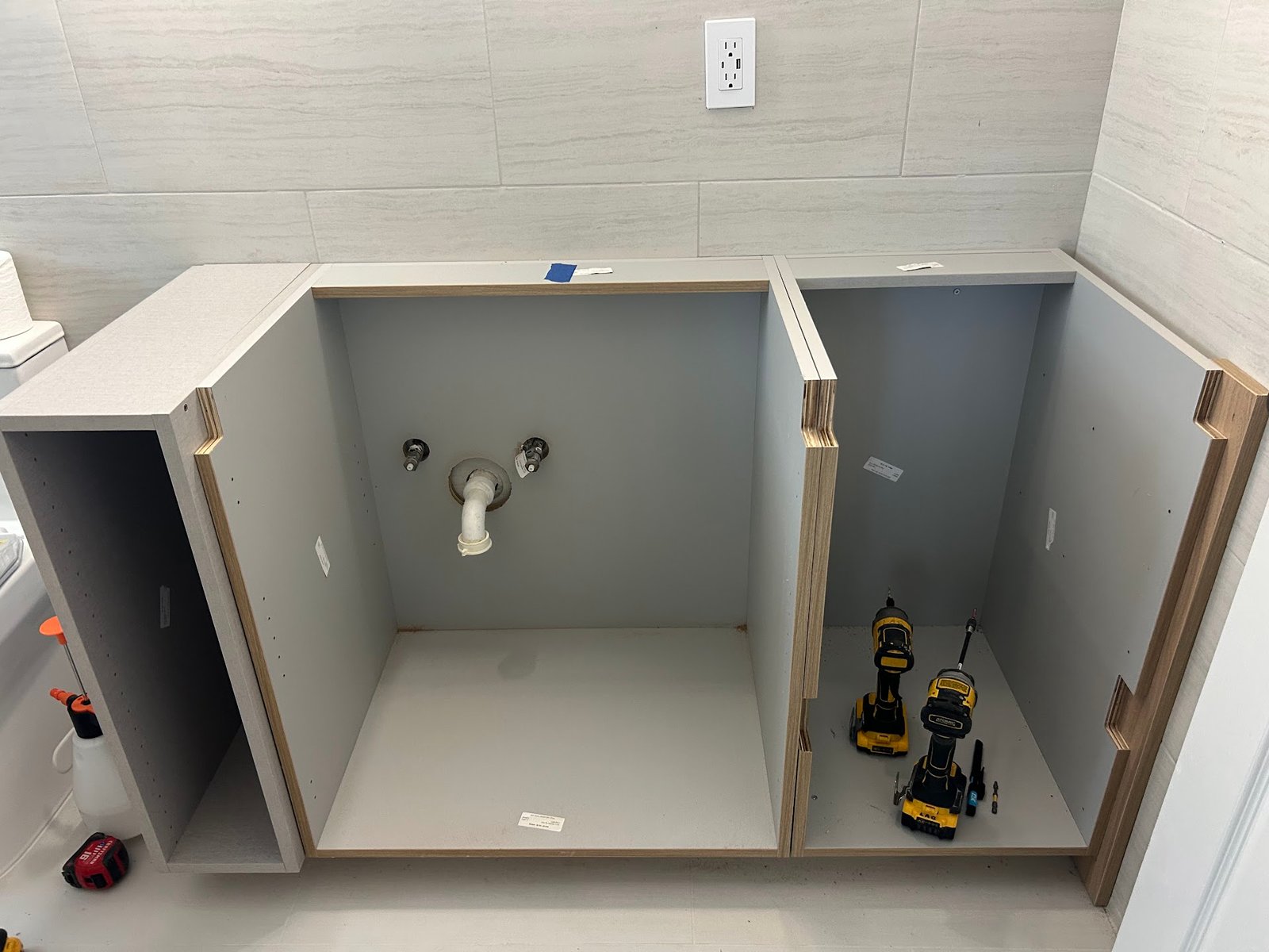 Vanity cabinet being leveled during installation by the M11 Design Group team in a South Florida home