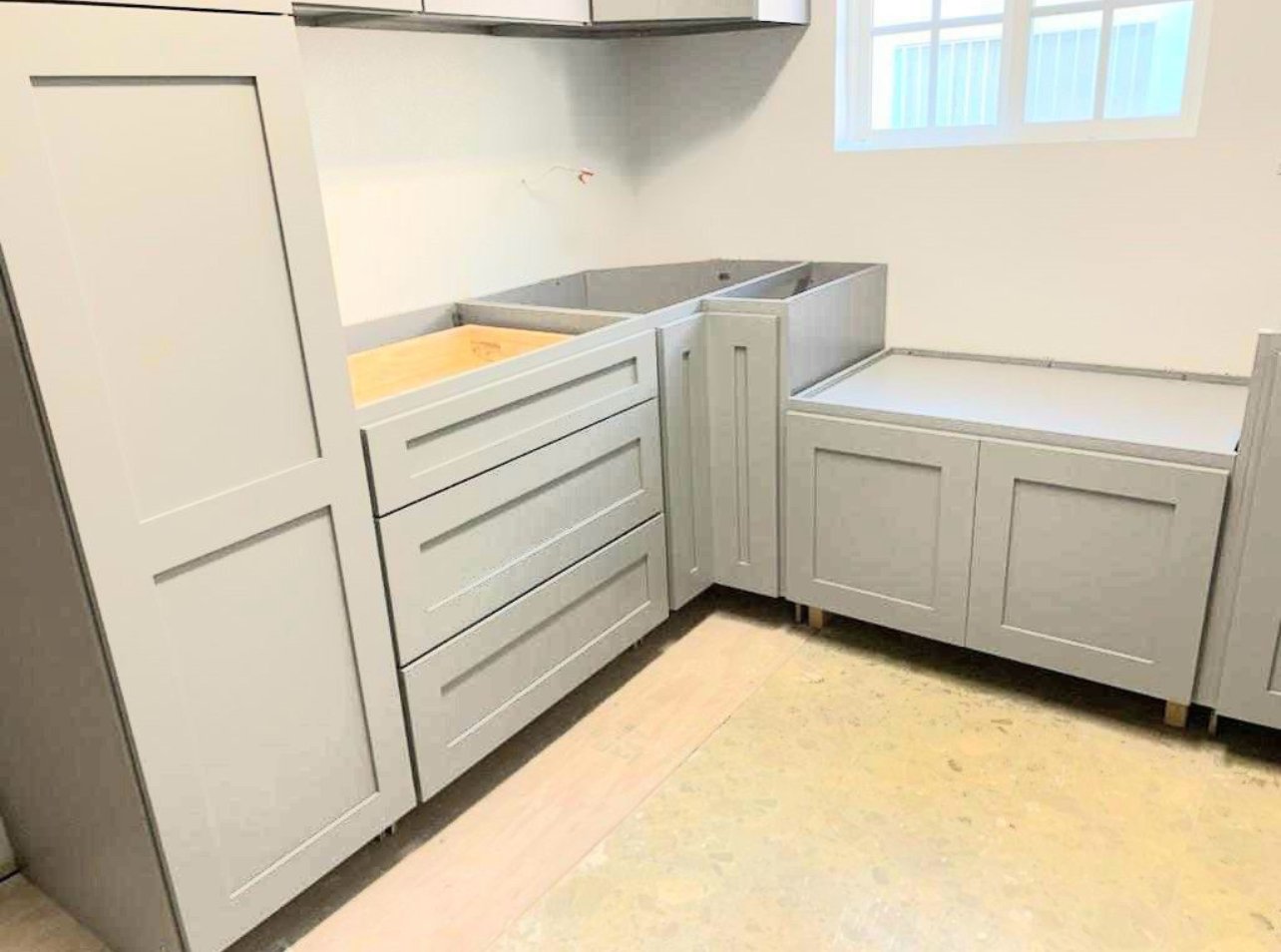 Cabinetry installed with the floor protected during installation day by M11 Design Group