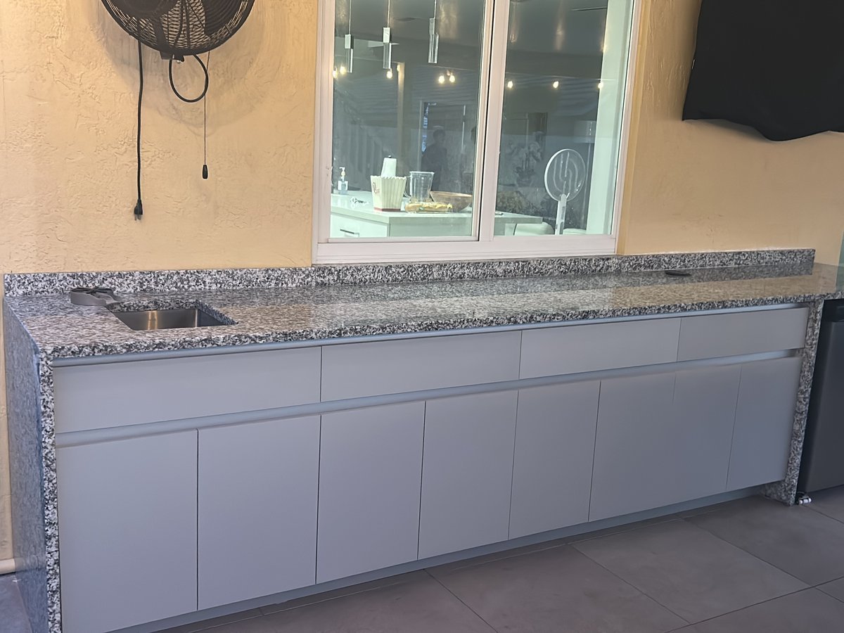 Outdoor kitchen cabinetry with granite top installed by M11 Design Group on a South Florida patio